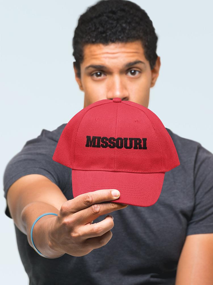 a man holding a red hat