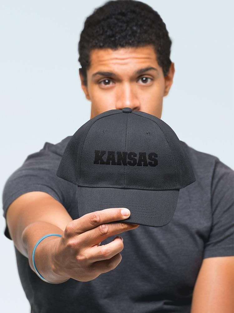 a man holding a black hat