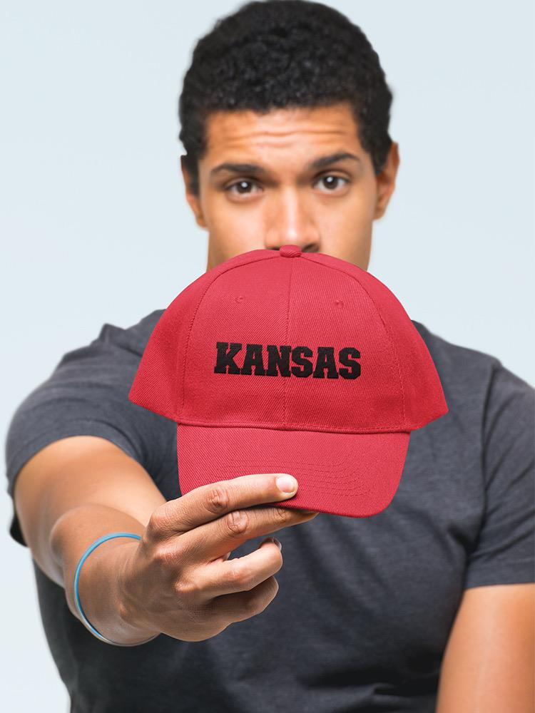 a man holding a red hat
