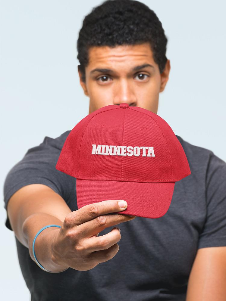 a man holding a red hat