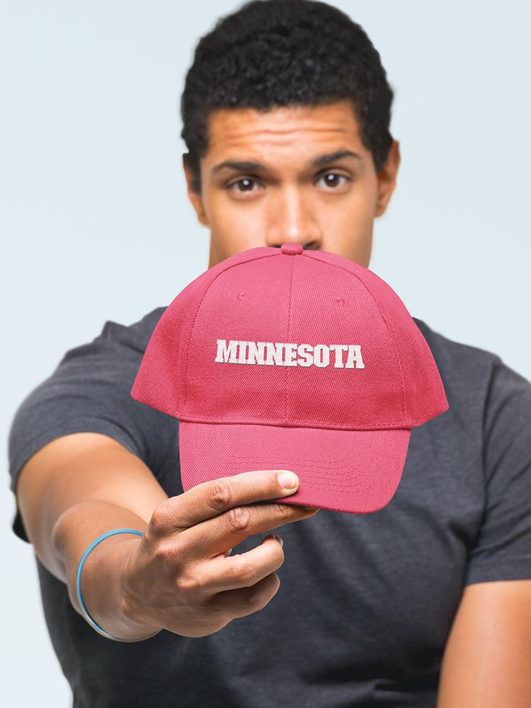 a man holding a red hat