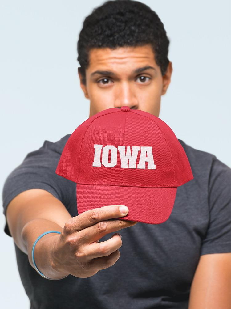 a man holding a red hat