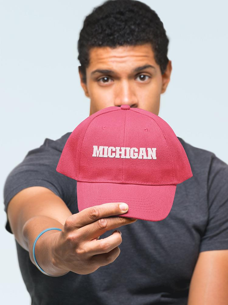 a man holding a red hat