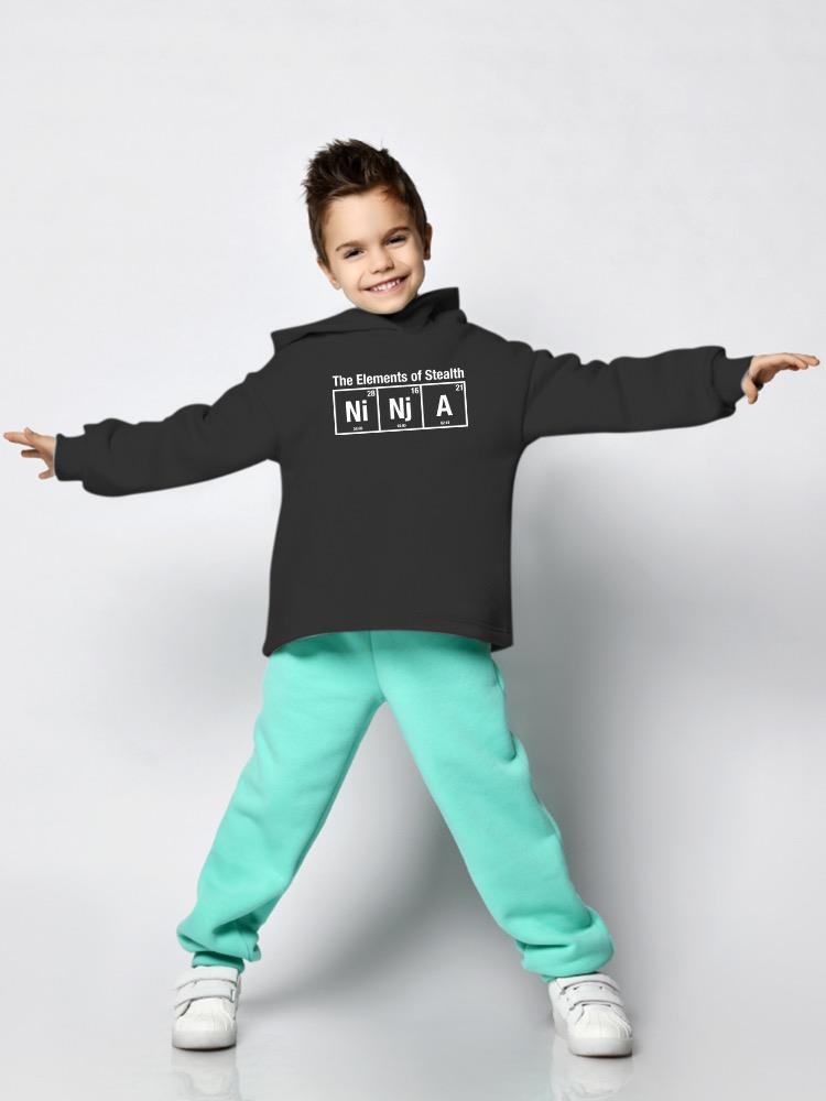 a boy wearing a black sweatshirt and mint pants