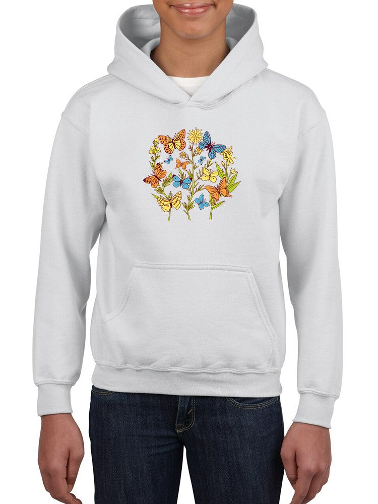 a person wearing a white hoodie with butterflies on it