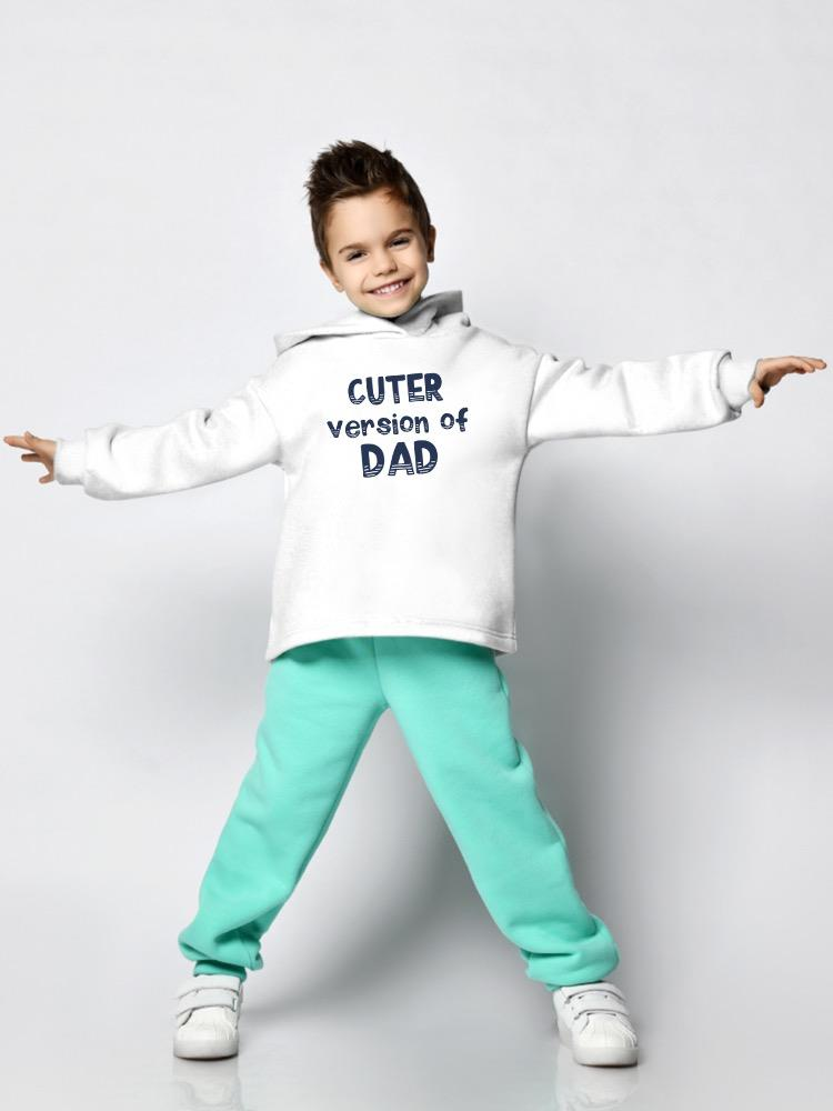 a boy wearing a white sweatshirt and mint pants