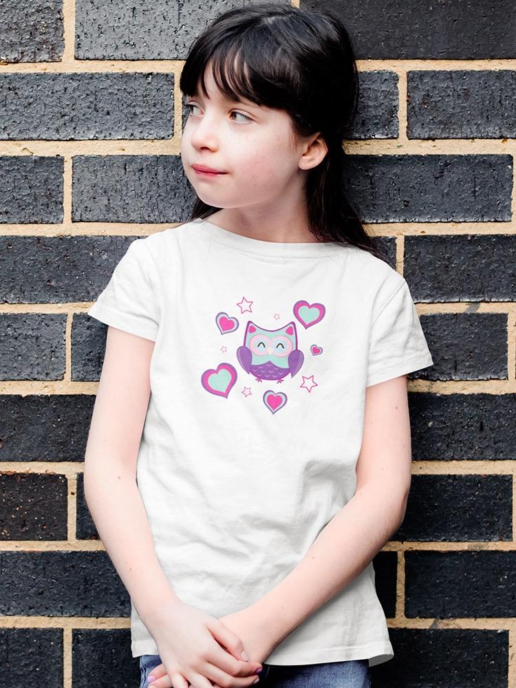 a girl standing against a brick wall