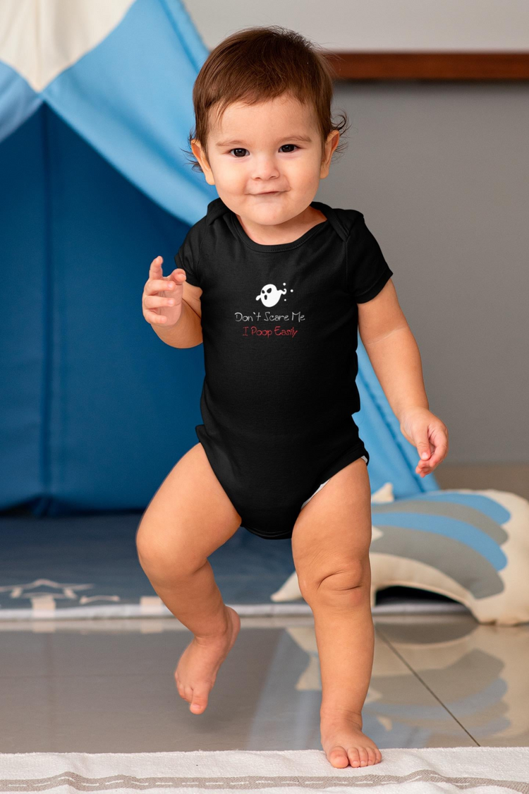 a baby standing on a floor