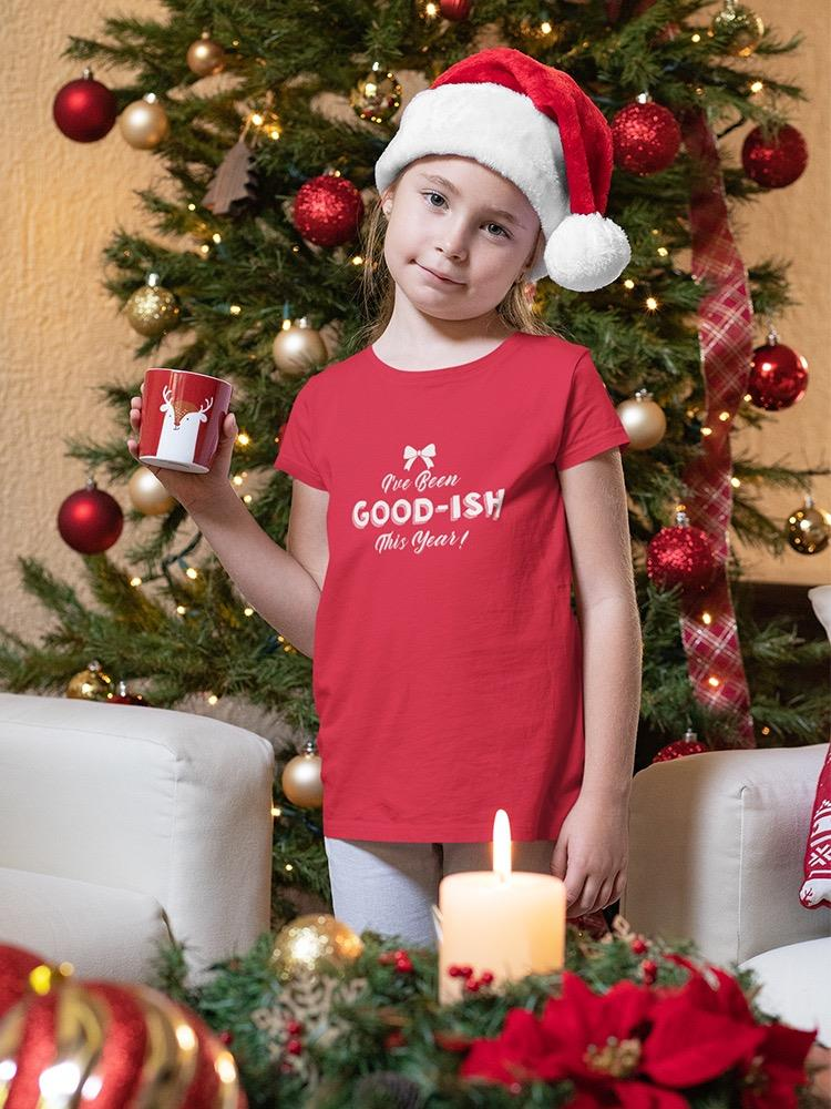 a girl in a santa hat holding a mug