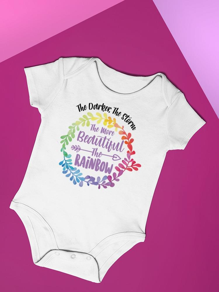 a white baby bodysuit with rainbow colors on it