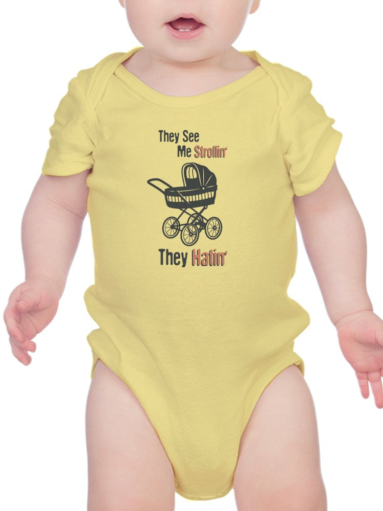 a baby wearing a yellow bodysuit