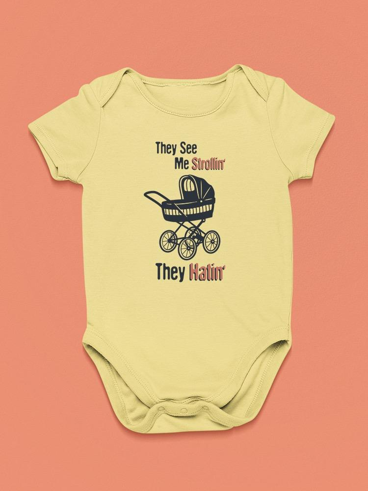 a yellow baby bodysuit with a picture of a stroller