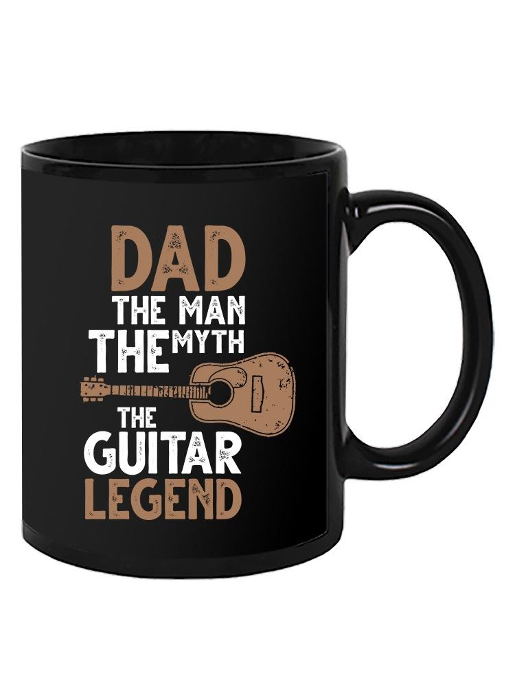 a black mug with white text and a guitar
