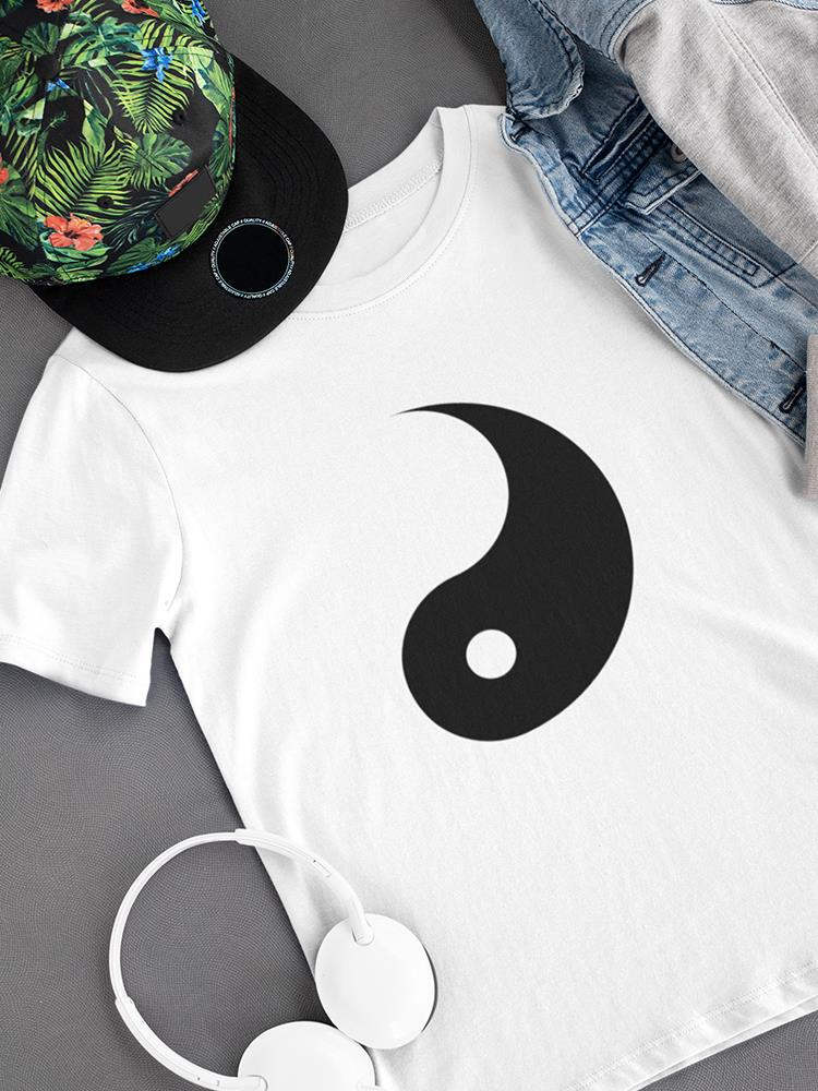 a white shirt with a black symbol on it and a hat and a pair of jeans