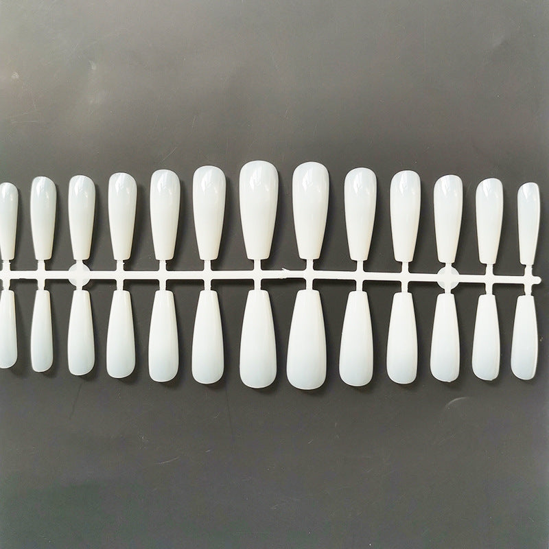 a plastic tray with long white nails