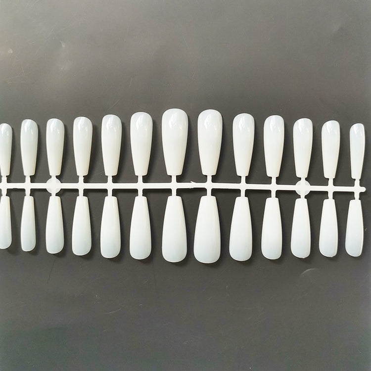 a plastic tray with long white nails