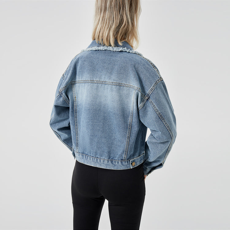a woman wearing a denim jacket