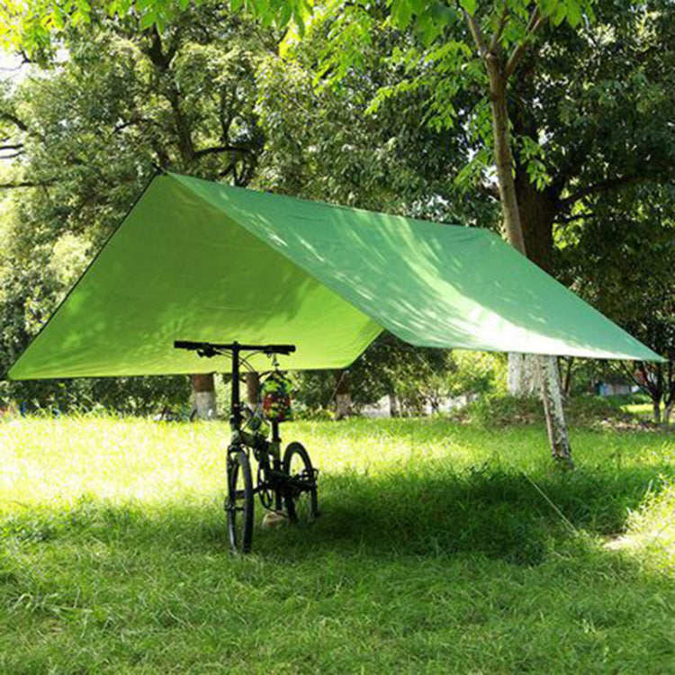 a bicycle under a green tarp