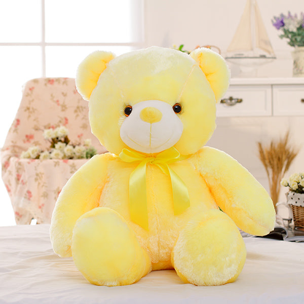 a yellow teddy bear on a table