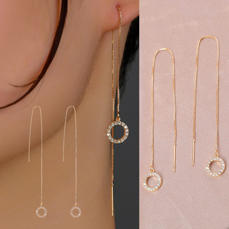 a woman wearing a gold earrings