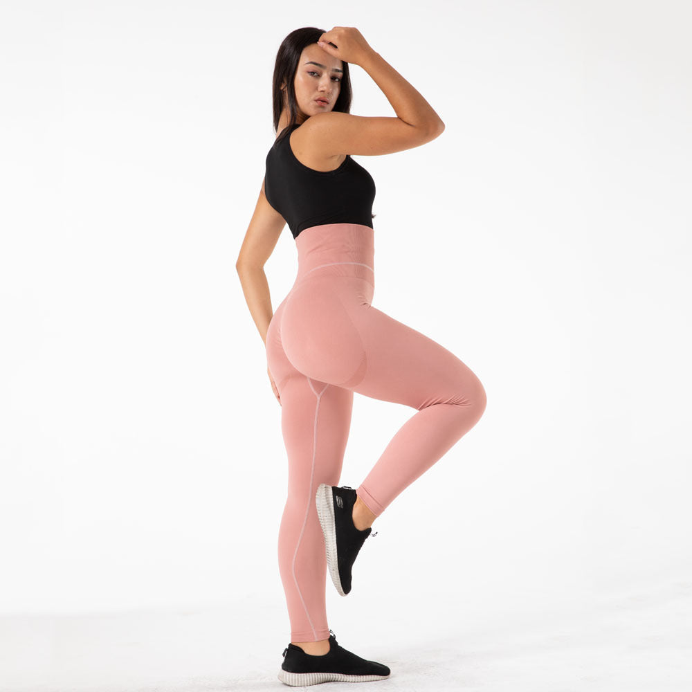 a woman in pink leggings and black tank top