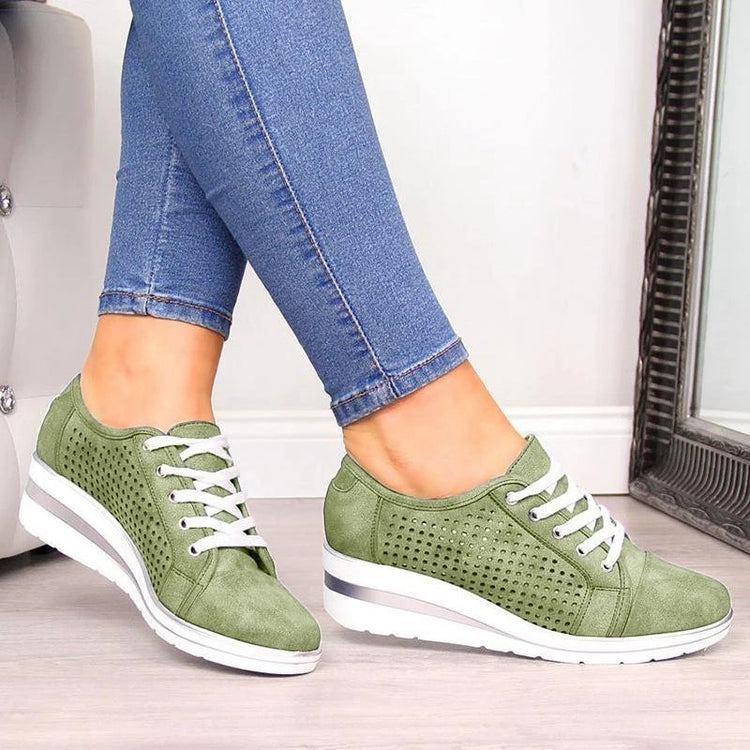 a pair of legs wearing jeans and green shoes