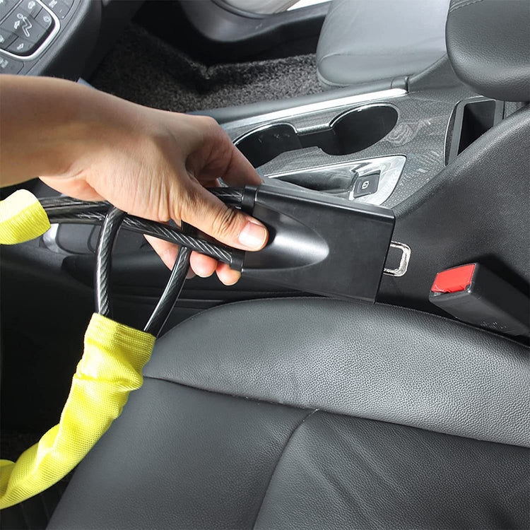 a person holding a vacuum in a car