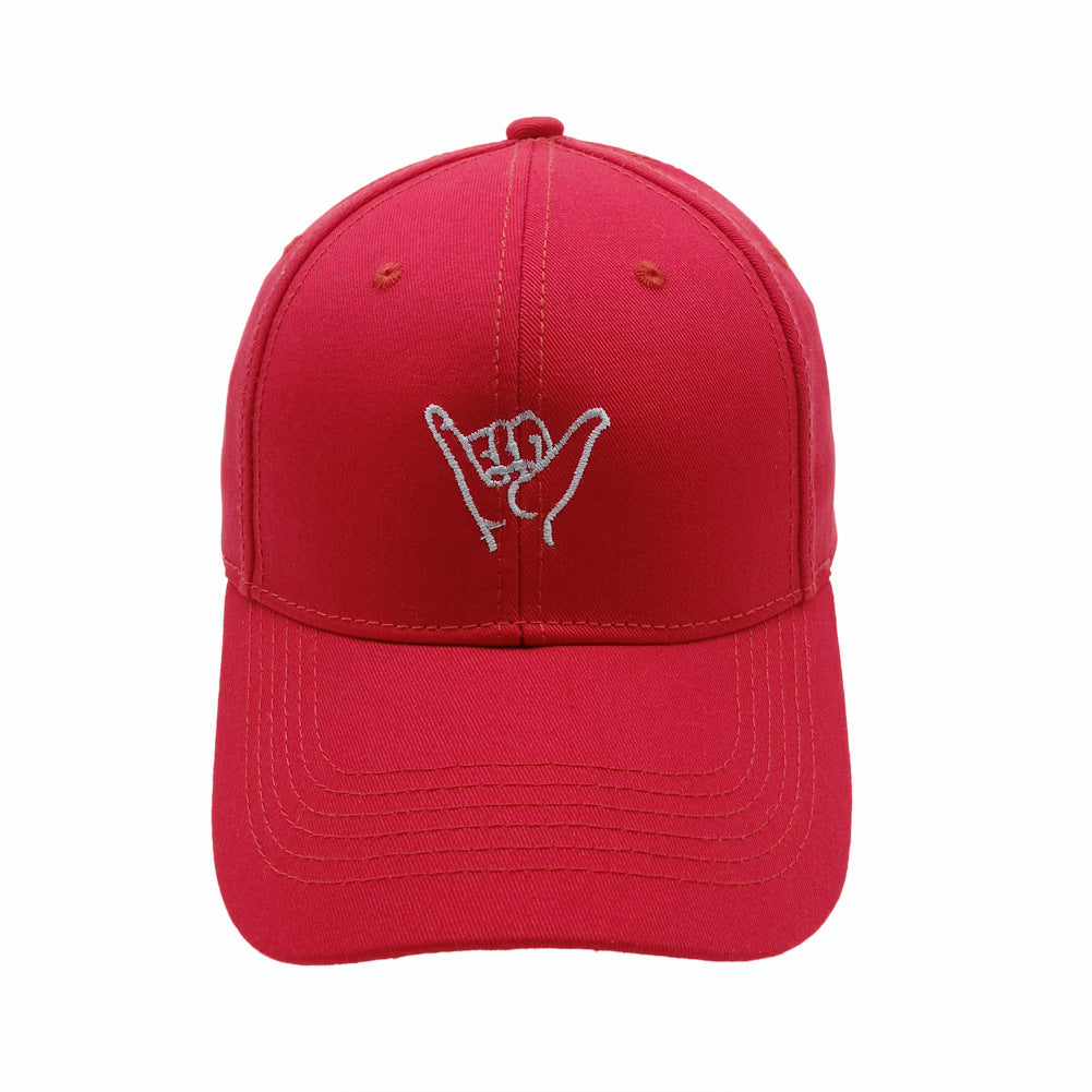 a red hat with a hand gesture on it