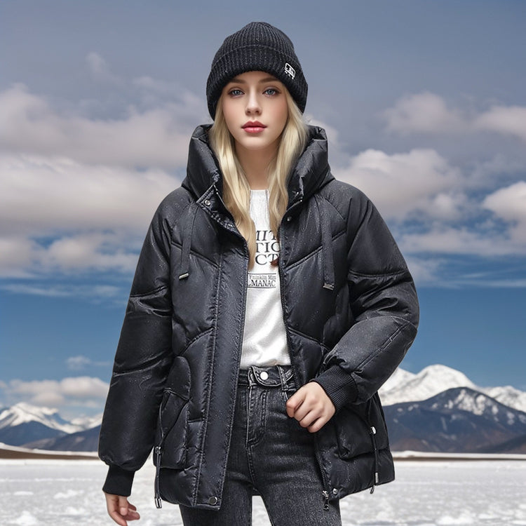 a woman in a black coat and hat standing in snow