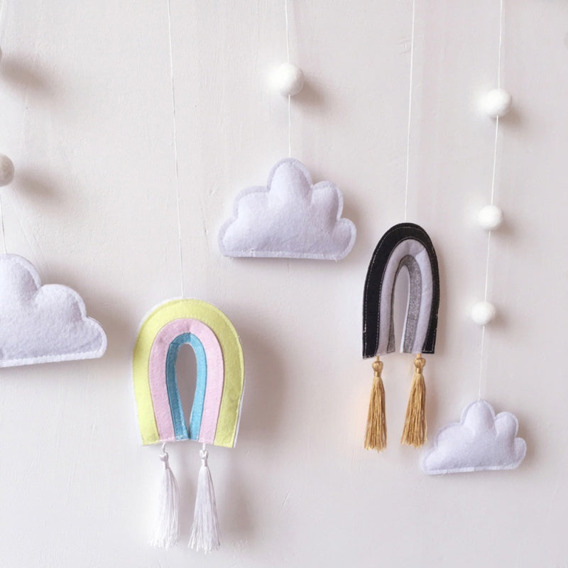 a group of felt toys on a wall