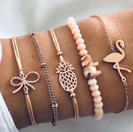 a wrist with many bracelets