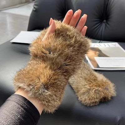 a hand with furry gloves