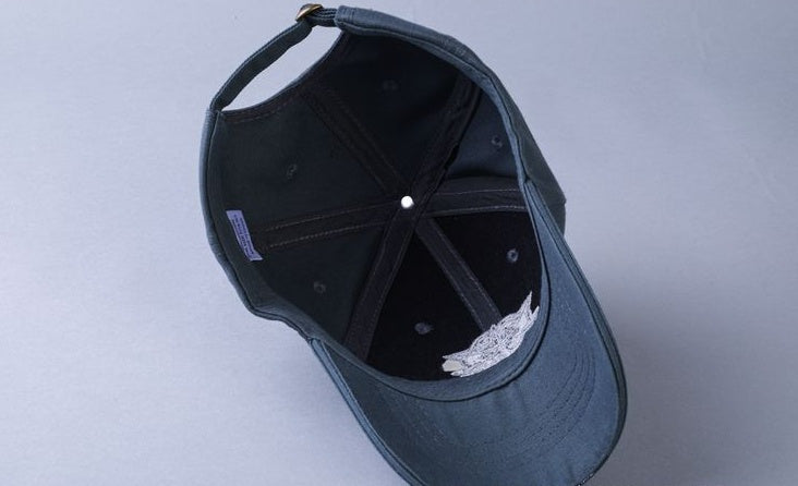 a black baseball cap with a white cloth inside