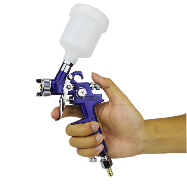 a person holding a spray gun
