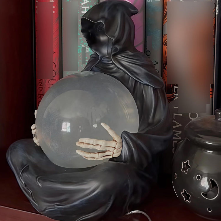 a statue of a person holding a crystal ball