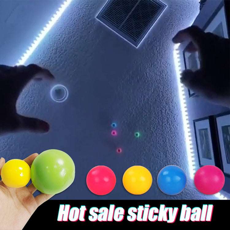 a hand holding colorful balls
