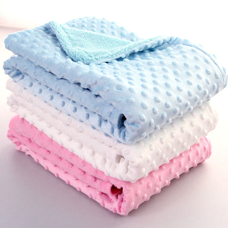 a stack of blankets on a white surface