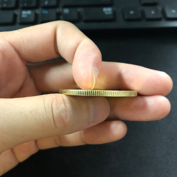 a hand holding a coin