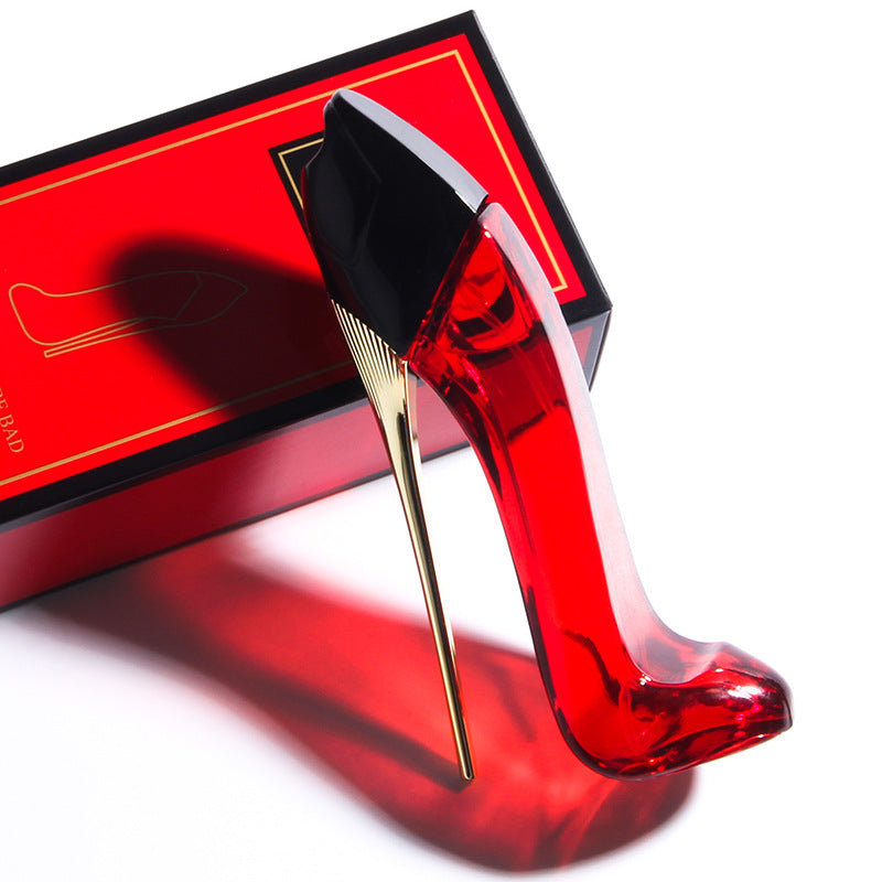 a red glass shoe on a red box