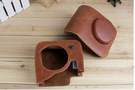a brown leather case with a round hole