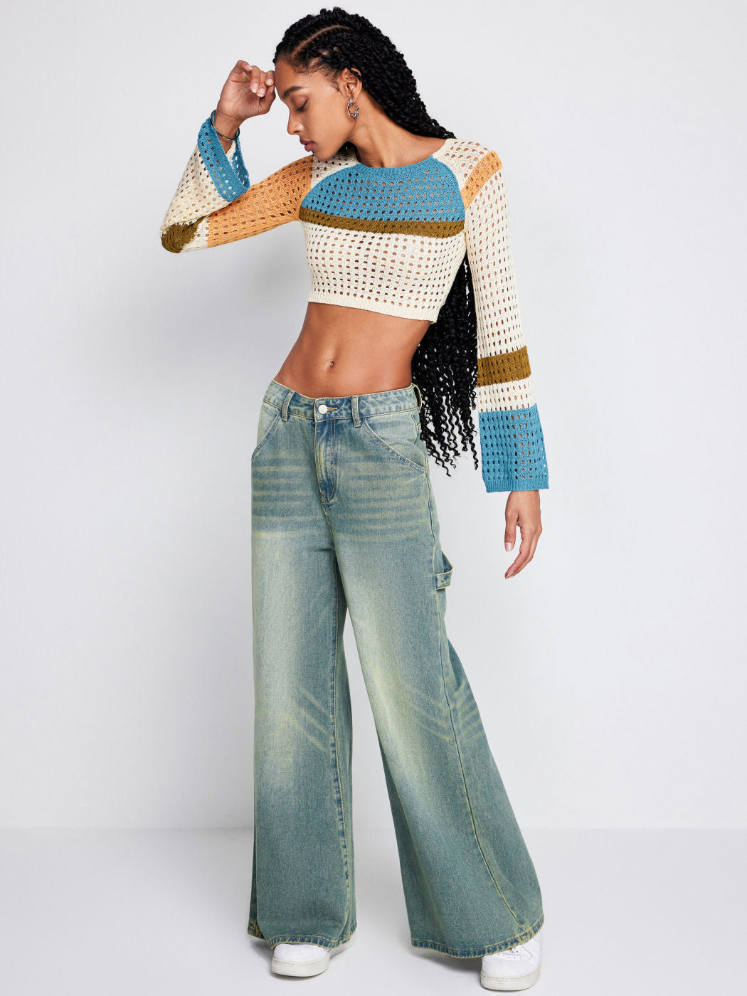 a woman in a sweater and jeans