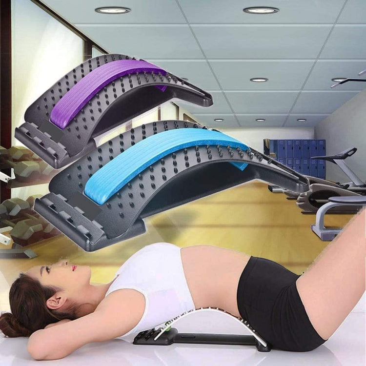a woman lying on a board with a few different colored objects