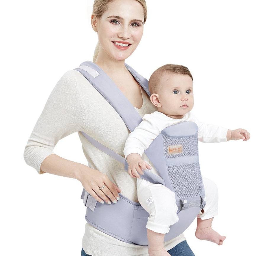 a woman carrying a baby