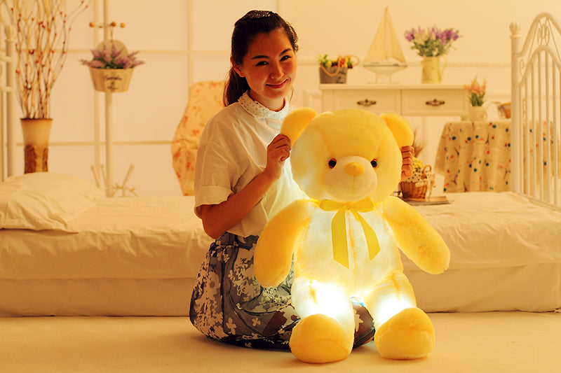 a woman holding a stuffed bear