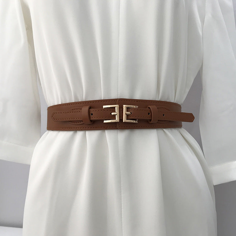 a brown belt on a white dress
