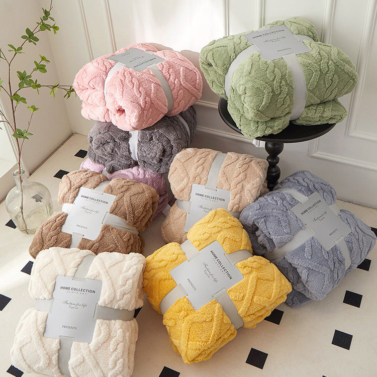 a stack of blankets on a black table