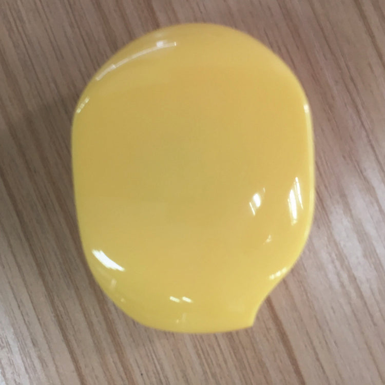 a yellow object on a wood surface