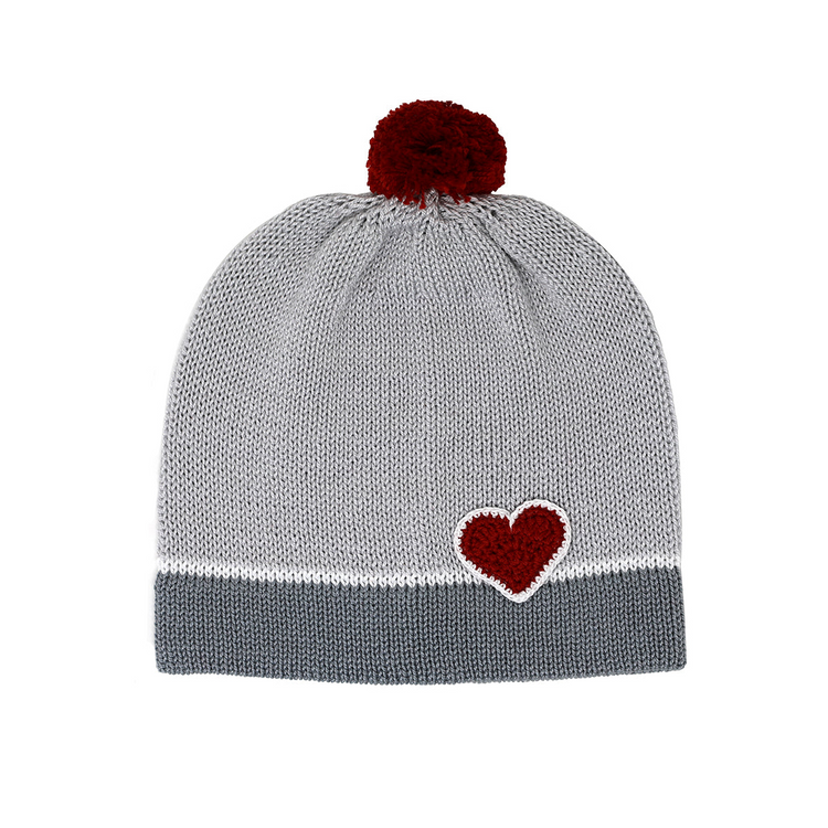 a grey and white knit hat with a red heart