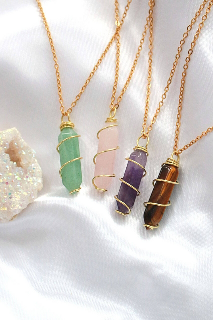a group of necklaces with different colored stones