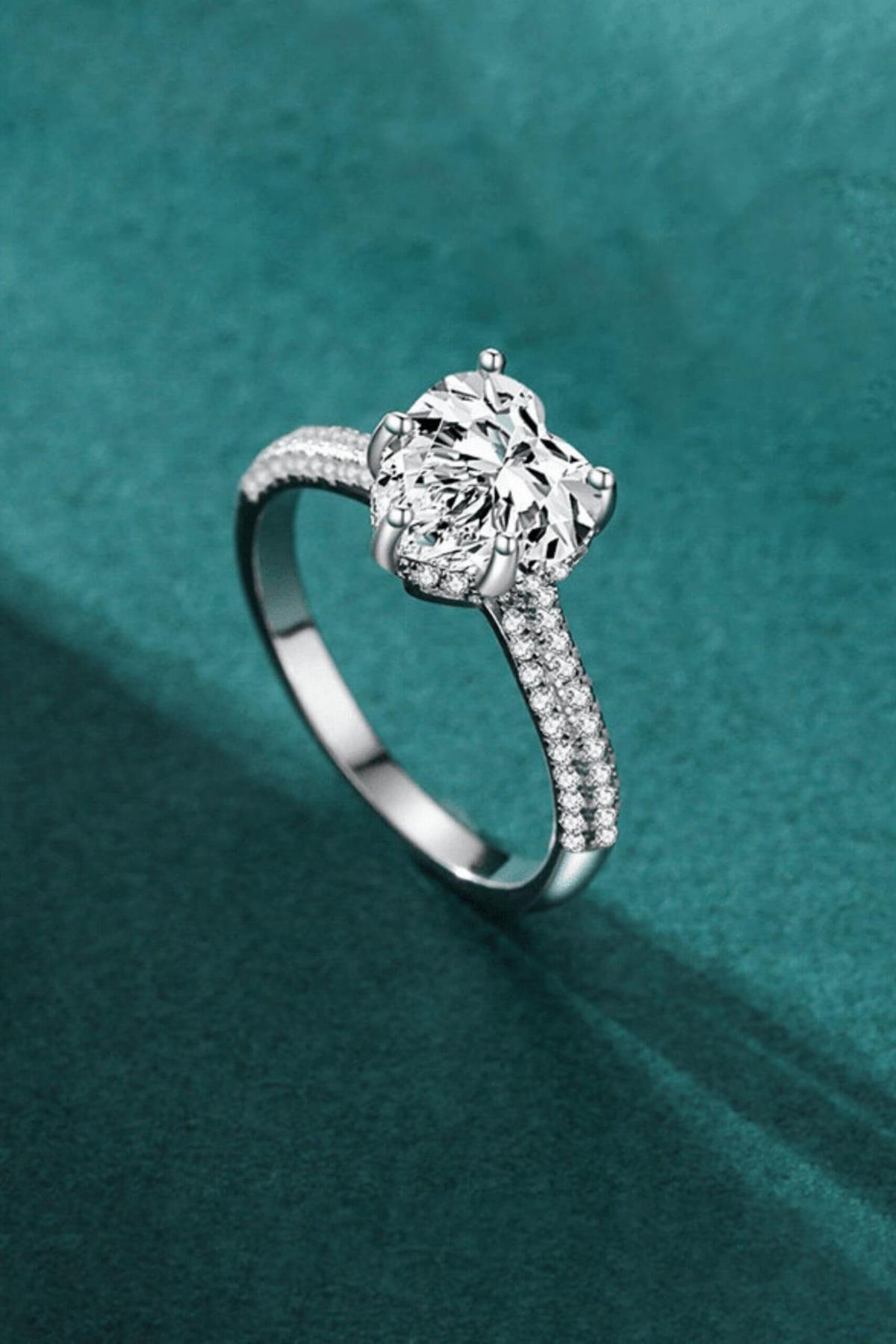 a diamond ring on a blue surface
